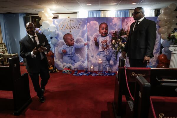 Security guards walk around before a funeral service for 1-year-old Daniel Coleman at Hollifield Mortuary in Atlanta on Saturday, Aug. 15, 2026. (Abbey Cutrer/AJC)