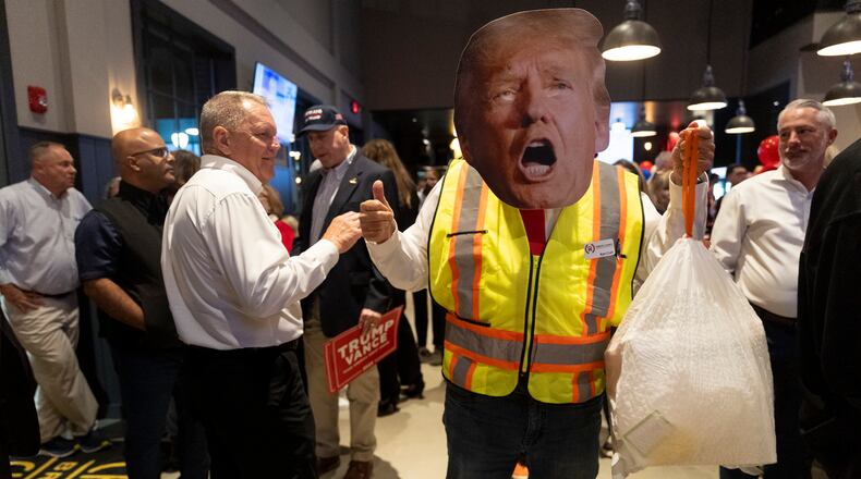 Ken Craft sported a Donald Trump costume at a GOP election night watch party in Cumming. “We are thrilled,” Craft said of Trump's election victory. “The basic issues that (Trump) talked about from the beginning — the economy, immigration and safety — just cut across all demographic groups all over the country.” (Nathan Posner for the Atlanta Journal-Constitution)