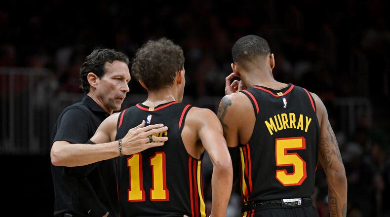 Atlanta Hawks head coach Quin Snyder confers with Atlanta Hawks' guard Trae Young (11) and Atlanta Hawks' guard Dejounte Murray (5) during the second half in Game 3 of the first round of the Eastern Conference playoffs at State Farm Arena, Friday, April 21, 2023, in Atlanta. Atlanta Hawks won 130-122 over Boston Celtics. (Hyosub Shin / Hyosub.Shin@ajc.com)
