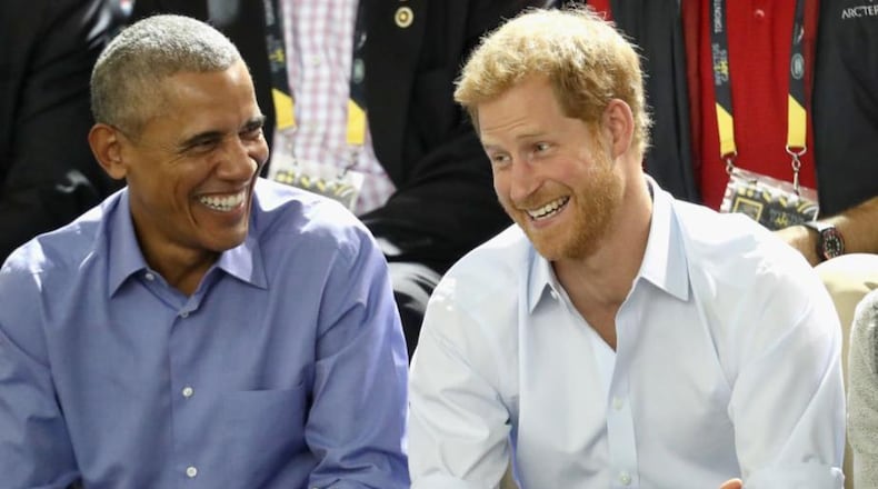 Former President Barack Obama, left, and Prince Harry share a joke during the Invictus Games in September.
