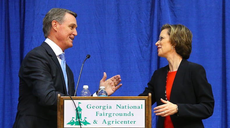 100714 PERRY: David Perdue and Michelle Nunn shake hands at the conclusion of the senate debate in Reaves Arena at the Georgia National Fair on Tuesday, Oct. 7, 2014, in Perry. CURTIS COMPTON / CCOMPTON@AJC.COM David Perdue and Michelle Nunn shake hands at the conclusion of the senate debate in Reaves Arena at the Georgia National Fair on Tuesday in Perry. Curtis Compton, ccompton@ajc.com