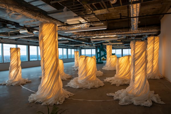 Roberto Rafael Navarrete’s "Boveda" is a series of fabric-wrapped columns that glow from within, presented as bovedas (altars). (Isadora Pennington/ArtsATL)