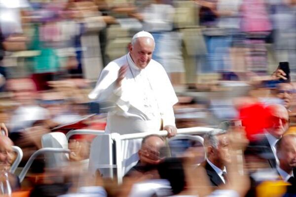 FILE - Pope Francis greets faithful after celebrating Mass on the occasion of the Migrant and Refugee World Day, in St. Peter's Square, at the Vatican, Sunday, Sept. 29, 2019. (AP Photo/Andrew Medichini, file)
