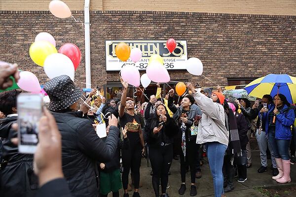 Mourners release balloons in memory of Anitra Gunn in front at the Eighteen36 Restaurant and Lounge, where she worked, in Fort Valley on Thursday, February 20, 2020. (Photo/Leah Yetter for the AJC)