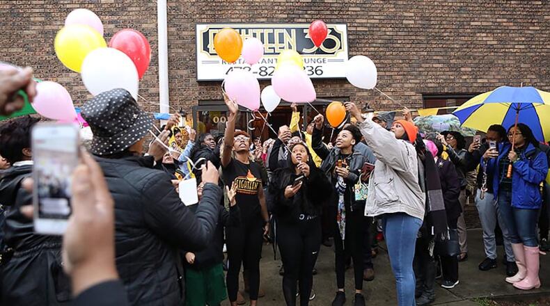Mourners release balloons in memory of Anitra Gunn in front at the Eighteen36 Restaurant and Lounge, where she worked, in Fort Valley on Thursday, February 20, 2020. (Photo/Leah Yetter for the AJC)
