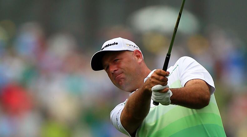 Stewart Cink, of Duluth, hits on the the No. 1 fairway during the opening round.