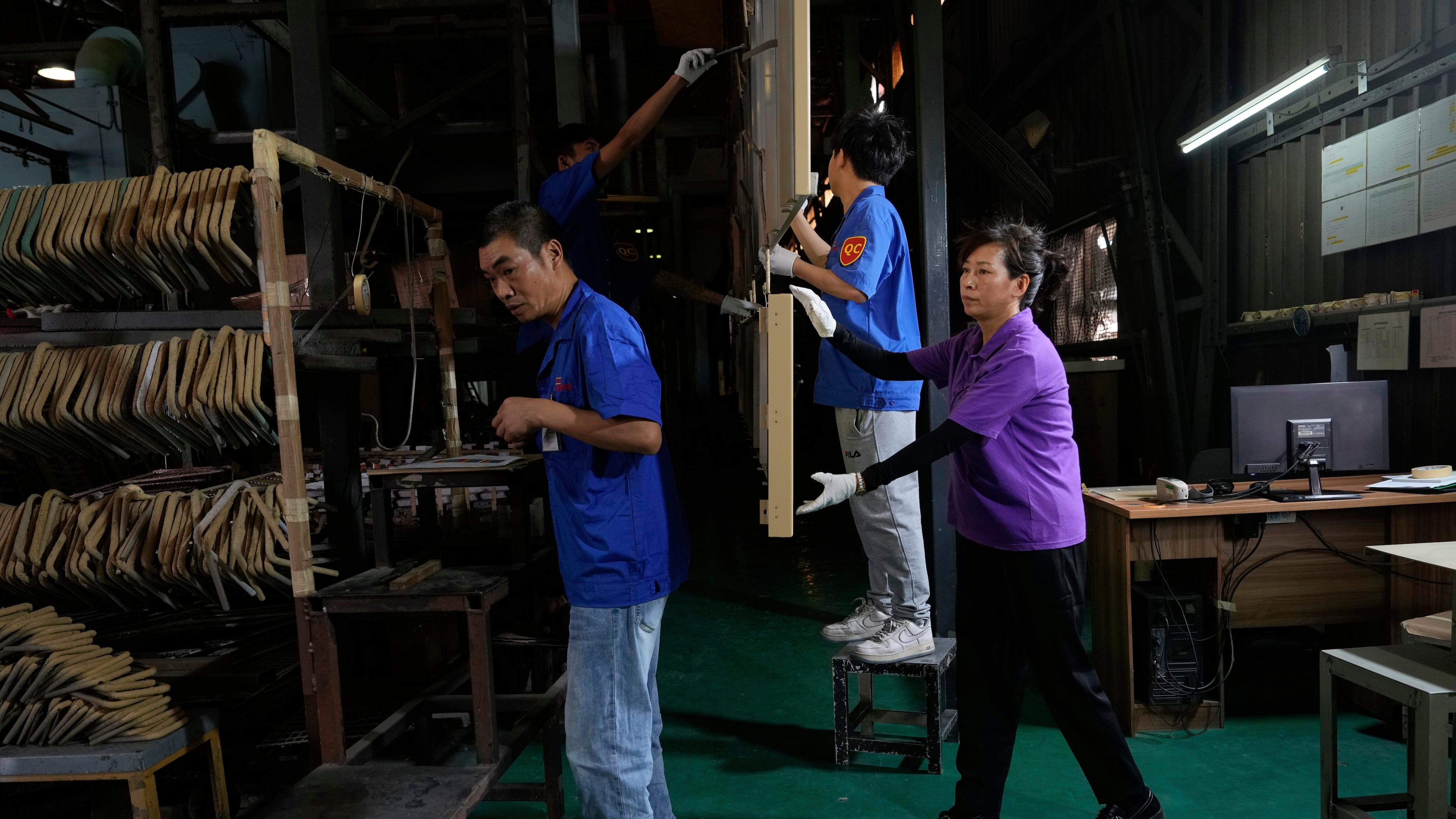 FILE - Workers check aluminum panels produced at a factory of Kam Pin Industrial (HK) Ltd, in Dongguan city in southern China's Guangdong province April 17, 2025. (AP Photo/Ng Han Guan, File)