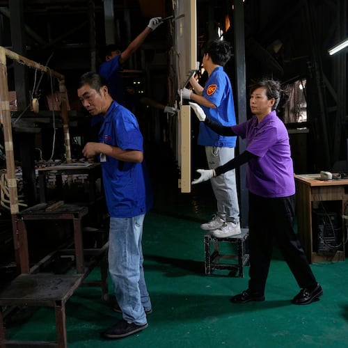 FILE - Workers check aluminum panels produced at a factory of Kam Pin Industrial (HK) Ltd, in Dongguan city in southern China's Guangdong province April 17, 2025. (AP Photo/Ng Han Guan, File)