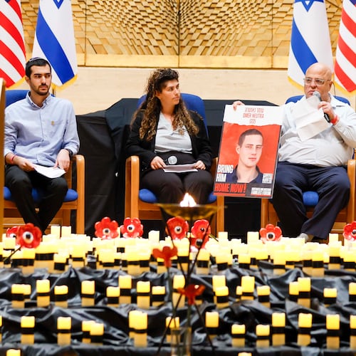 Bobby Harris (right) displays a portrait of Oct. 7 hostage Omer Neutra as he shares a personal story at the Ahavath Achim Synagogue on Sunday.