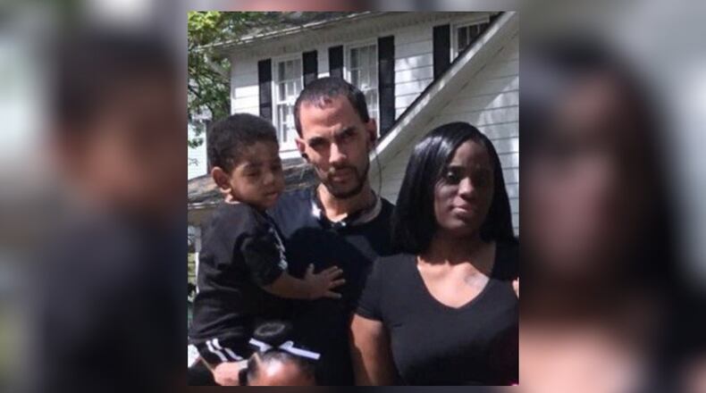 Anthony Dickerson holds his son, Anthony Jr., in a photo with the child's mother, Carmellia Burgess.