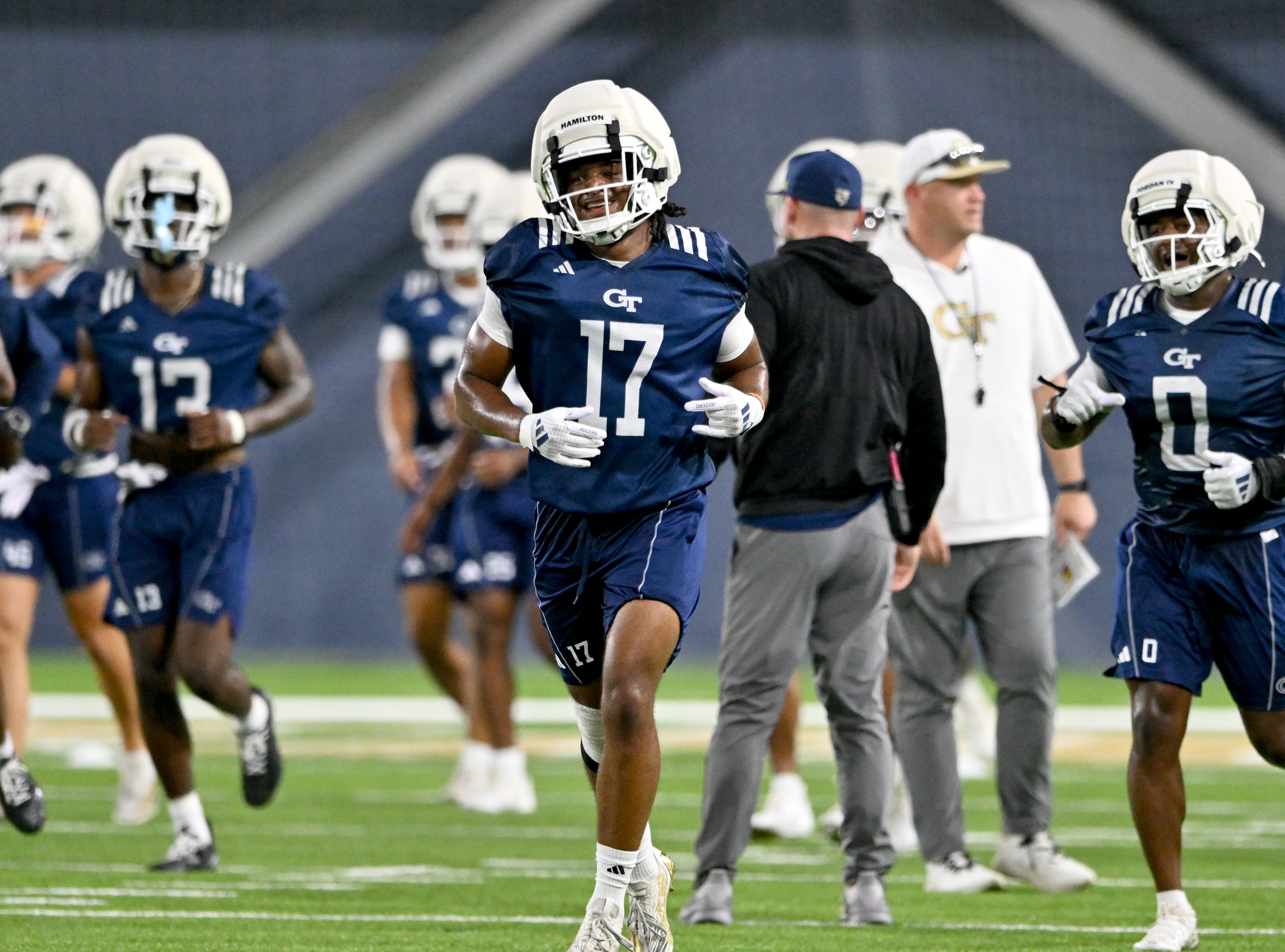 Georgia Tech linebacker Jackson Hamilton (17) smiles as he and other players warm up during the first day of football practice at Rose Bowl Field and the Mary and John Brock Football Practice Facility, Tuesday, July 29, 2025, in Atlanta. (Hyosub Shin / AJC)