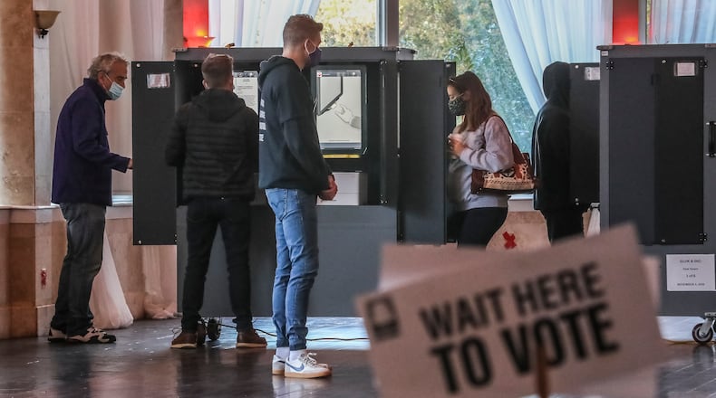November 3, 2020 Atlanta: Voters at the voting machines at Park Tavern in Atlanta on Tuesday, Nov. 3, 2020. Voters lined up outside polling places Tuesday morning to be among the first to cast their votes on a crucial Election Day. It’s expected to be the biggest day of voting in Georgia, with turnout reaching as high as 2 million. Another 3.9 million people already cast early or absentee ballots. Some told The Atlanta Journal Constitution that they expect social unrest whether Biden or Trump wins the election. (John Spink / John.Spink@ajc.com)