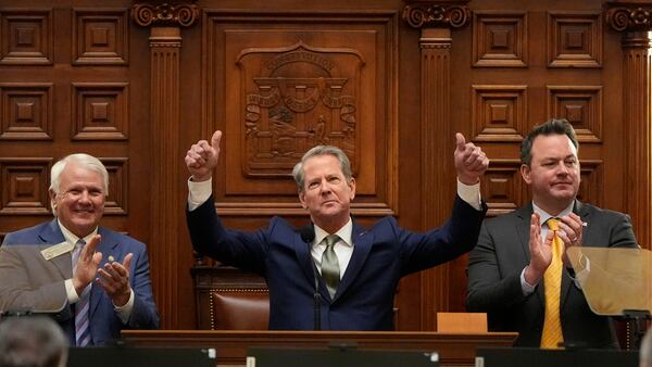 Gov. Brian Kemp (center) gestures after delivering his State of the State address at the Capitol in Atlanta on Thursday. He is flanked by House Speaker Jon Burns (left) and Lt. Gov. Burt Jones. (Brynn Anderson/AP)