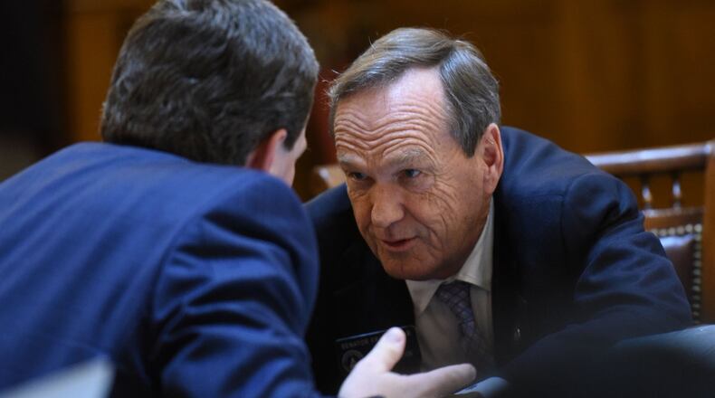 State Sen. Fran Millar, R-Dunwoody, (right) confers with state Sen. Charlie Bethel, R-Dalton, during the debate on House Bill 859, which would legalize firearms at all public colleges in Georgia. Millar was the only Republican to vote against the bill, which the Senate gave final passage to on a 37-17 vote. HYOSUB SHIN / HSHIN@AJC.COM