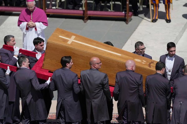 Pallbearers carry the coffin during the funeral of Pope Francis in St. Peter's Square at the Vatican, Saturday, April 26, 2025. (AP Photo/Markus Schreiber)