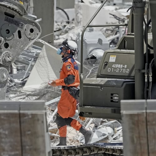 A firefighter searches the damaged AEON Mall following an explosion triggered by an earthquake in Kashima, Kumamoto Prefecture, southern Japan, Friday, July 31, 2026. (Kai Naito/Kyodo News via AP)
