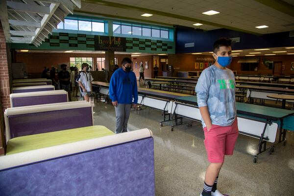 Students stand socially distant in the cafeteria as they purchase their school lunches at Cartersville Middle School in Cartersville, Thursday, August 20, 2020. (ALYSSA POINTER / ALYSSA.POINTER@AJC.COM)