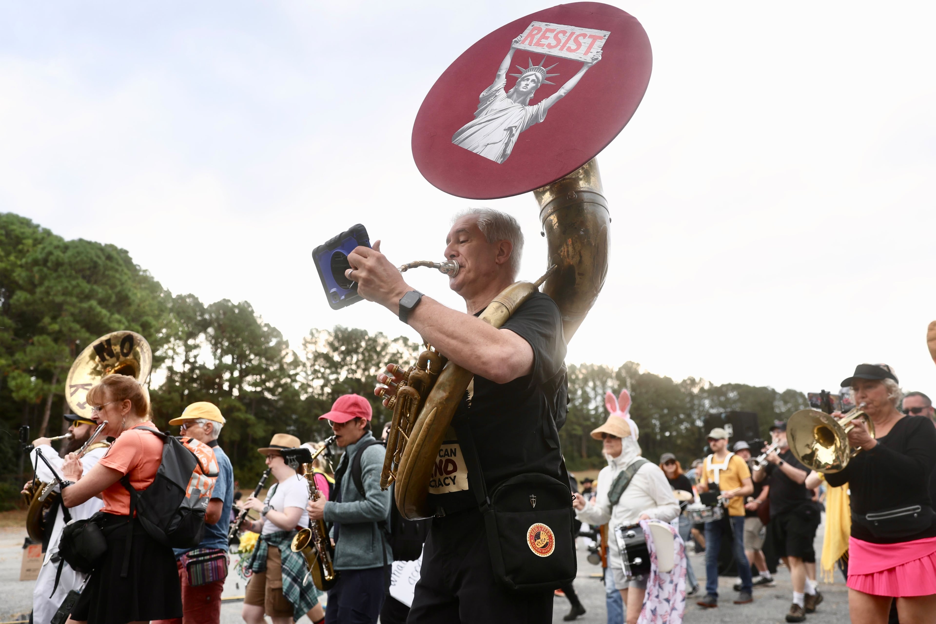 Hundreds of people gathered at the Atlanta Civic Center parking lot Saturday morning for a "No Kings" protest. (Abbey Cutrer / AJC)