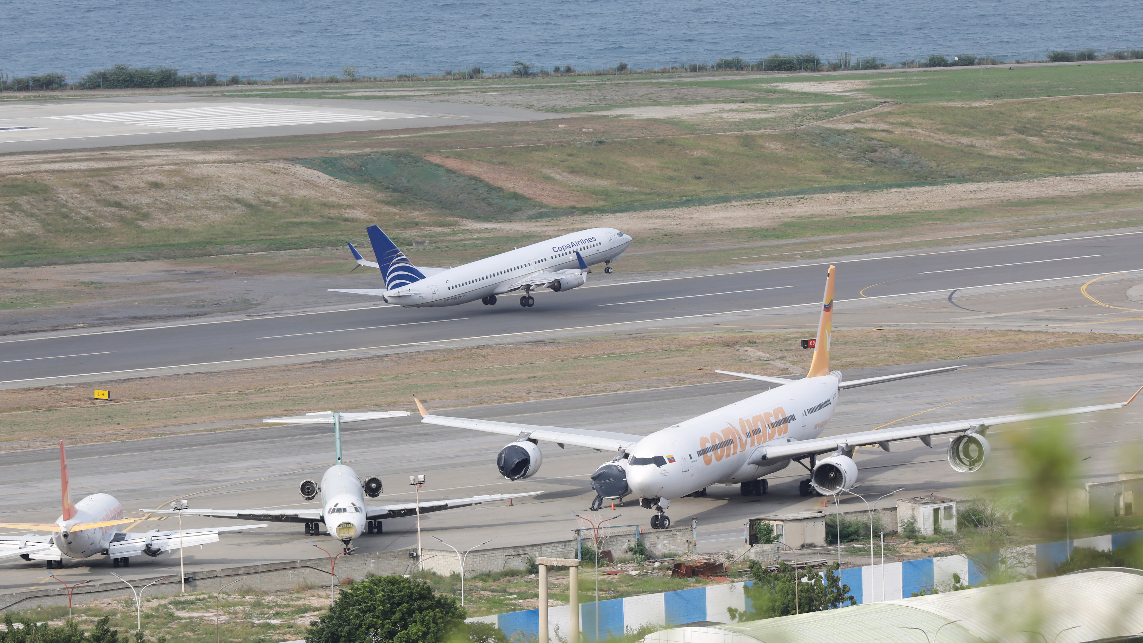 A COPA Airlines plane takes off at Simon Bolivar International Airport in Maiquetia, Venezuela, Monday, Dec. 1, 2025, days after the government revoked operating rights for international airlines that suspended flights following a warning from the U.S. Federal Aviation Administration.(AP Photo/Cristian Hernandez)