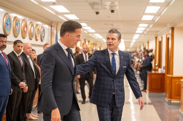 Defense Secretary Pete Hegseth, right, walks to a meeting with NATO Secretary General Mark Rutte, left, following an Honor Cordon at the Pentagon, Thursday, April 24, 2025 in Washington. (AP Photo/Kevin Wolf)