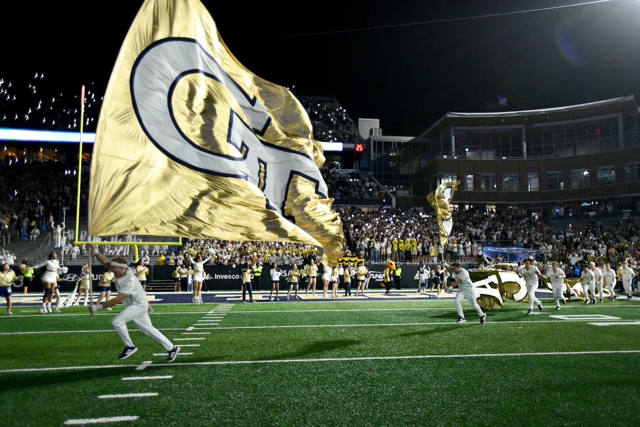 Georgia Tech's Ramblin' Wreck leads the band, cheerleaders, Buzz, players, and coaches before the start of the final regular-season home game against Pittsburgh at Bobby Dodd Stadium, Saturday, Nov. 22, 2025, in Atlanta. (Hyosub Shin/AJC)