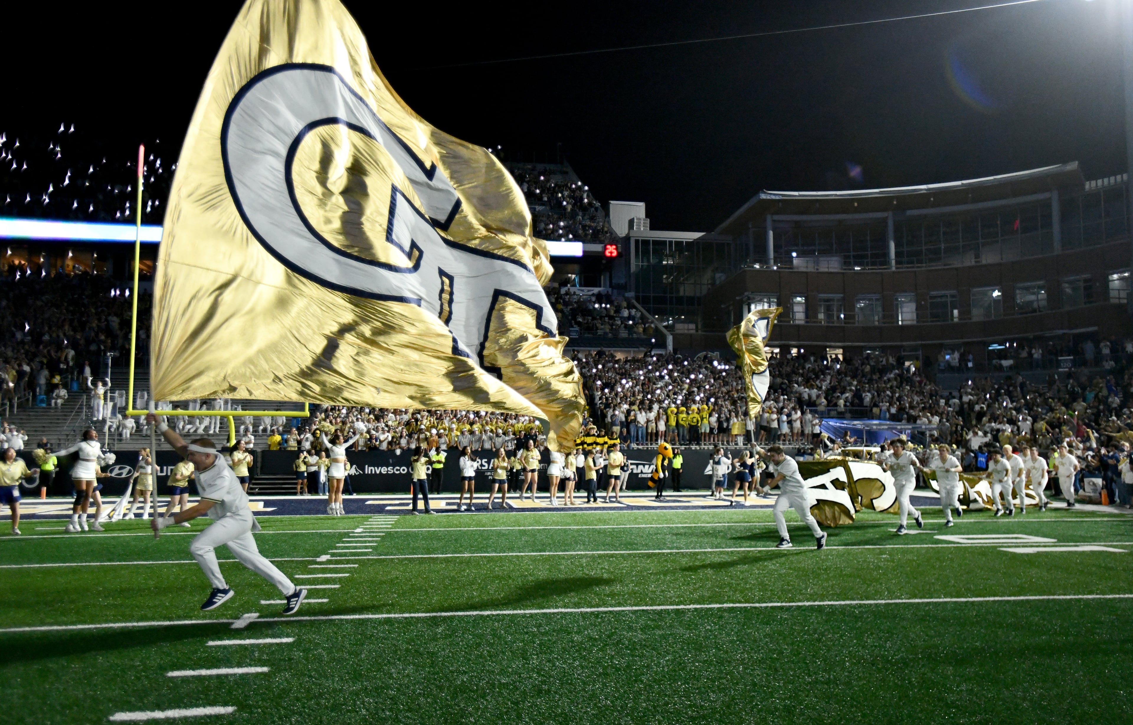 Georgia Tech's Ramblin' Wreck leads the band, cheerleaders, Buzz, players, and coaches before the start of the final regular-season home game against Pittsburgh at Bobby Dodd Stadium, Saturday, November 22, 2025 in Atlanta. (Hyosub Shin / AJC)