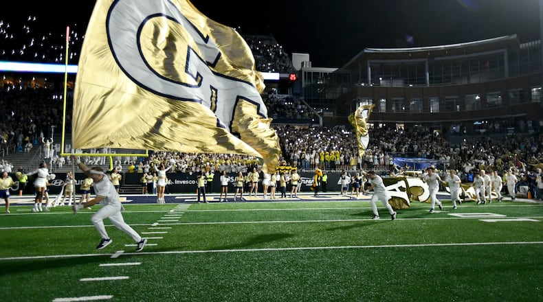 Georgia Tech's Ramblin' Wreck leads the band, cheerleaders, Buzz, players, and coaches before the start of the final regular-season home game against Pittsburgh at Bobby Dodd Stadium, Saturday, November 22, 2025 in Atlanta. (Hyosub Shin/AJC)