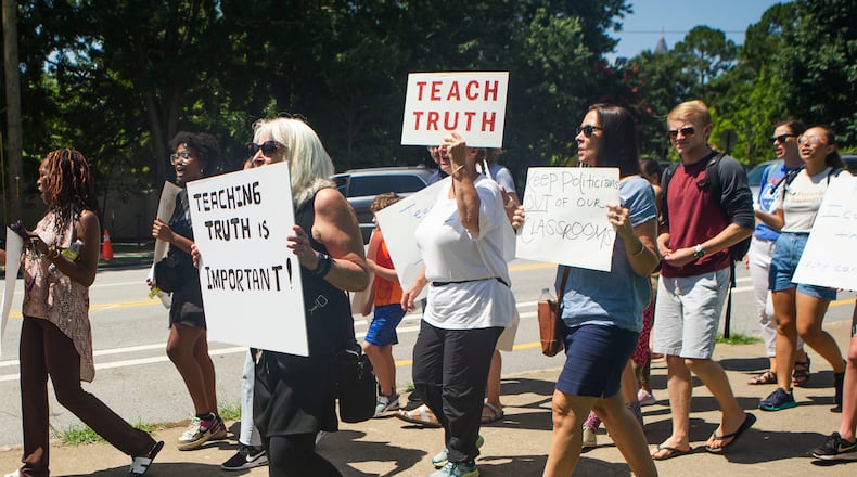 Educators and community members march in July 2022 at Piedmont Park in Atlanta against new state legislative action banning selected books from school libraries and prohibiting the teaching of divisive concepts, related to race, in U.S. history. The Georgia Professional Standards Commission is considering a proposal to scrub the mention of diversity from a state teacher preparation program. (Christina Matacotta for The Atlanta Journal-Constitution)