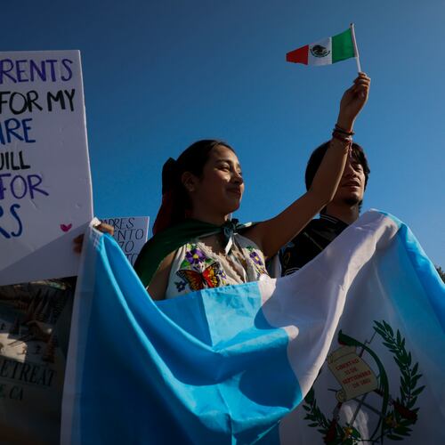 Demonstrators waving Latin American flags in support of immigration gather along Buford Highway in Norcross on Feb. 9, 2025. (Miguel Martinez/AJC)