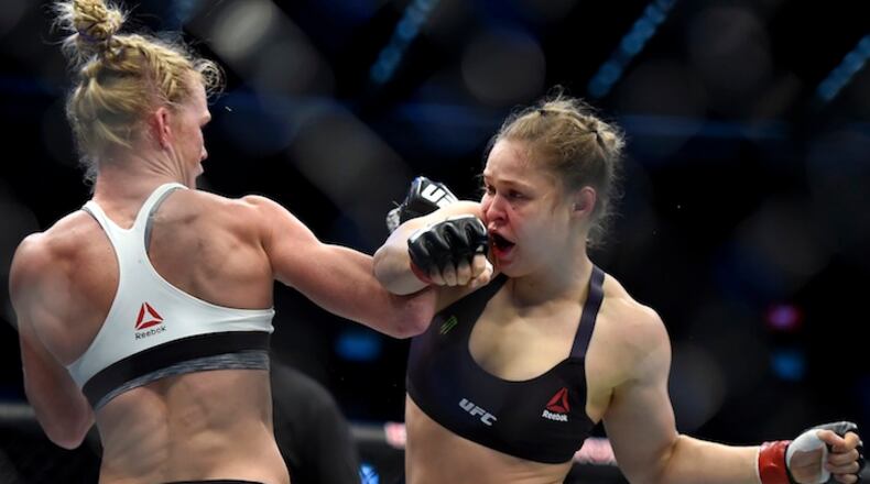 Holly Holm, left punches Ronda Rousey during thier UFC 193 Bantamweight title fight in Melbourne, Australia, Sunday, Nov. 15, 2015. (AP Andy Brownbill)