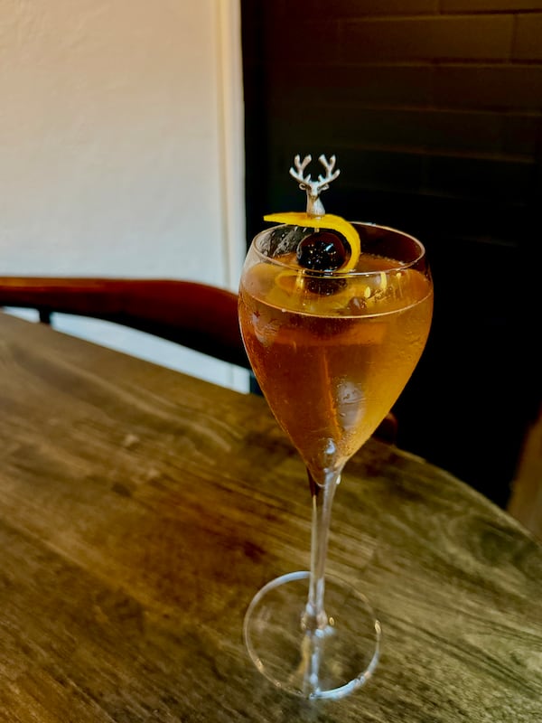 Fawn's Spanish Pipedream is a layered yet balanced blend of amari, vermouth and sherry that bubbles with peach essence. (Angela Hansberger for the AJC)