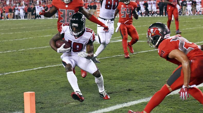 Atlanta Falcons wide receiver Taylor Gabriel (18) runs past Tampa Bay Buccaneers cornerback Brent Grimes, right, for a 9-yard touchdown during the first half of an NFL football game in Tampa, Fla., Thursday, Nov. 3, 2016. (AP Photo/Jason Behnken)