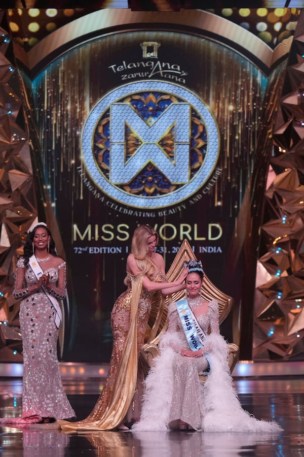 Krystyna Pyszkova of Czech Republic, crowns her successor Opal Suchata of Thailand after she who won the 72nd Miss World pageant in Hyderabad, India, Saturday, May 31, 2025. (AP Photo/Mahesh Kumar A.)