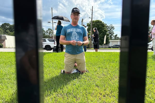 A man prays the Rosary outside the gates of the Broad River Road Correctional Facility in Columbia, S.C., before the scheduled execution of Stephen Stanko on Friday, June 14, 2025. (AP Photo/Allen G. Breed)