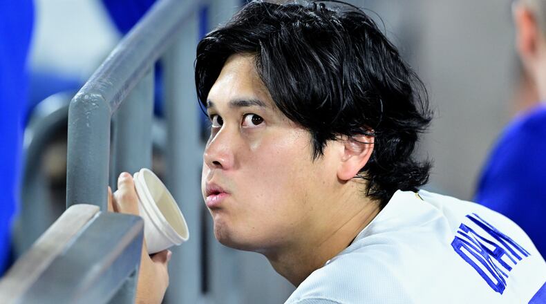 Los Angeles Dodgers Shohei Ohtani (17) watches from the dugout during the seventh inning of a baseball game against the Seattle Mariners, Tuesday, July 28 2026, in Los Angeles. (AP Photo/Wally Skalij)