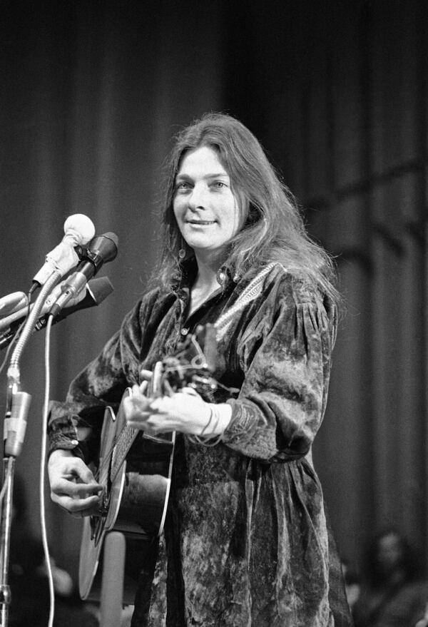 FILE - Singer-songwriter Judy Collins performs at a rally in support of the Berrigan brothers, Feb. 20, 1971. (AP Photo/Jim Wells, File)