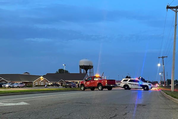 Emergency vehicles block a road leading to a building where a car smashed through during an after-school program, killing several people and injuring others, Monday, April 28, 2025, in Chatham, Ill. (AP Photo/John O'Connor)