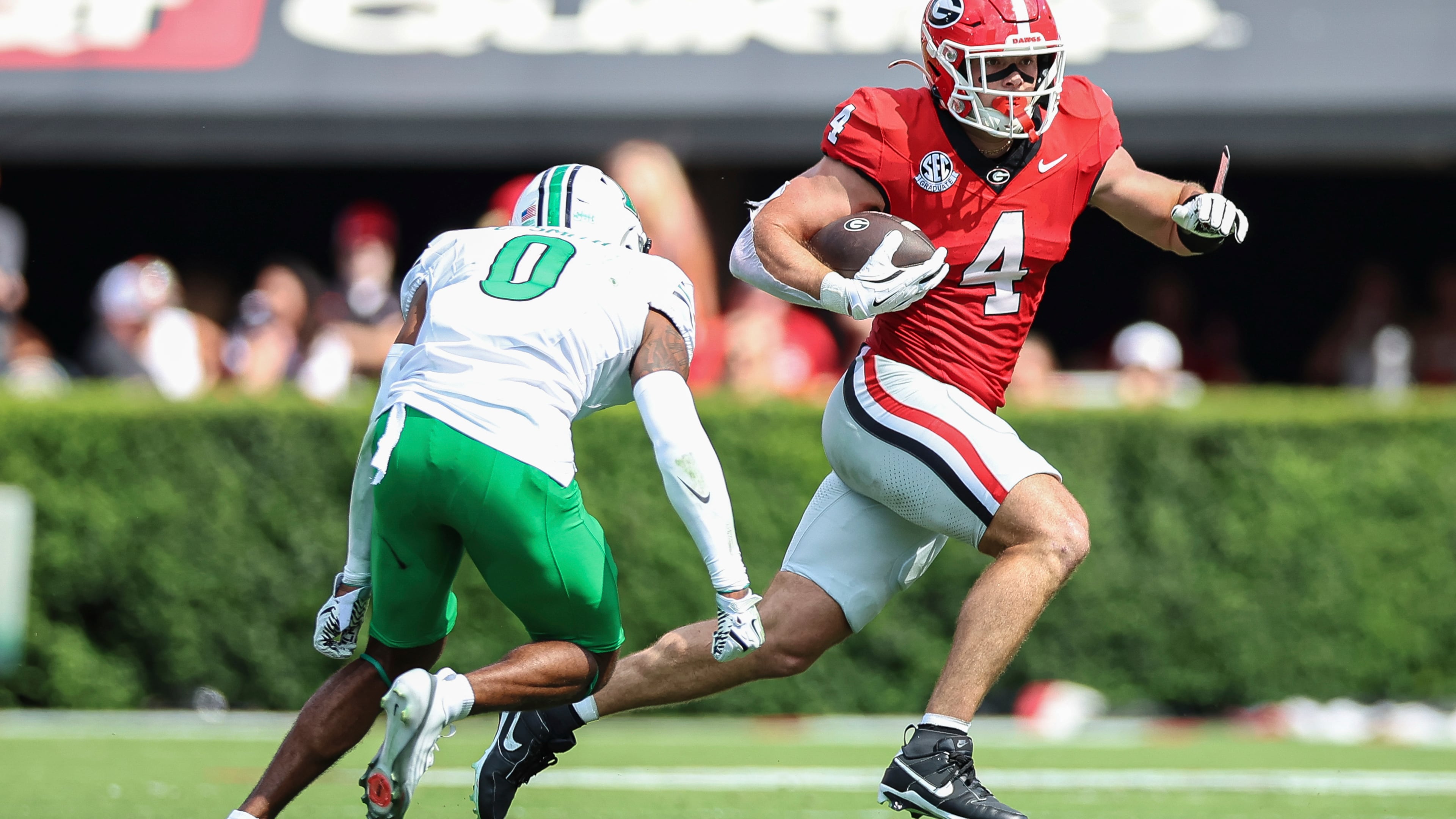 Georgia tight end Oscar Delp (right) runs the football during the first half against Marshall on Saturday, Aug. 30, 2025, in Athens. The Bulldogs cruised to a 45-7 win over the Thundering Herd. (Colin Hubbard/AP)