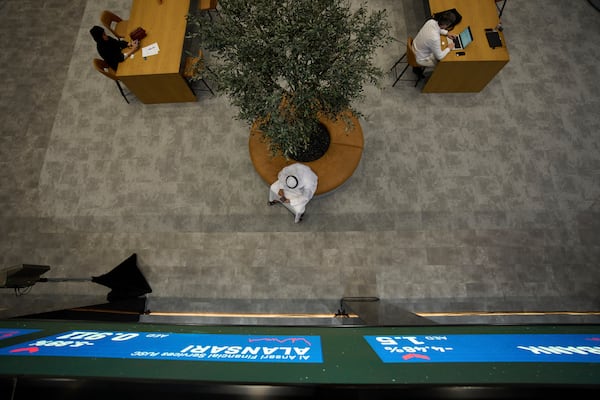 Emiratis are seen in the Dubai Financial Market in Dubai, United Arab Emirates, Monday, April 7, 2025. (AP Photos/Fatima Shbair)