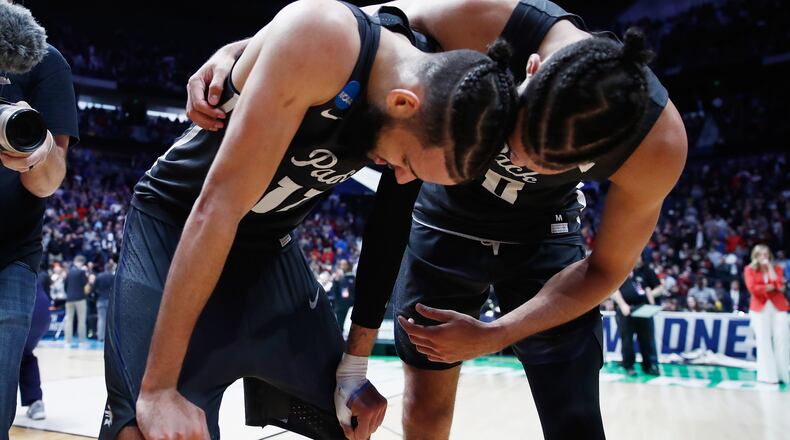 Nevada's Caleb Martin (right) celebrates with twin brother Cody Martin after the Wolf Pack defeated No. 2-seed Cincinnati Sunday. Or is that Cody on the right? (Andy Lyons/Getty Images)