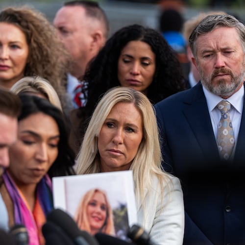 Rep. Marjorie Taylor Greene, R-Ga., second from right, and Rep. Thomas Massie, R-Ky., right, react during a news conference on the Epstein Files Transparency Act, Tuesday, Nov. 18, 2025, outside the U.S. Capitol in Washington. (AP Photo/Julia Demaree Nikhinson)
