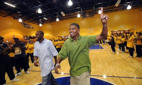 Angelo Taylor (left) and Terrence Trammell appear at an Olympic sendoff in 2008 at Southwest DeKalb High School. The former SWD track stars were coached by Napoleon Cobb, who died Jan. 30 at age 80.