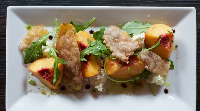 The Georgia peach salad at Vine & Tap features peach skin cracklins. Photo: Henri Hollis.