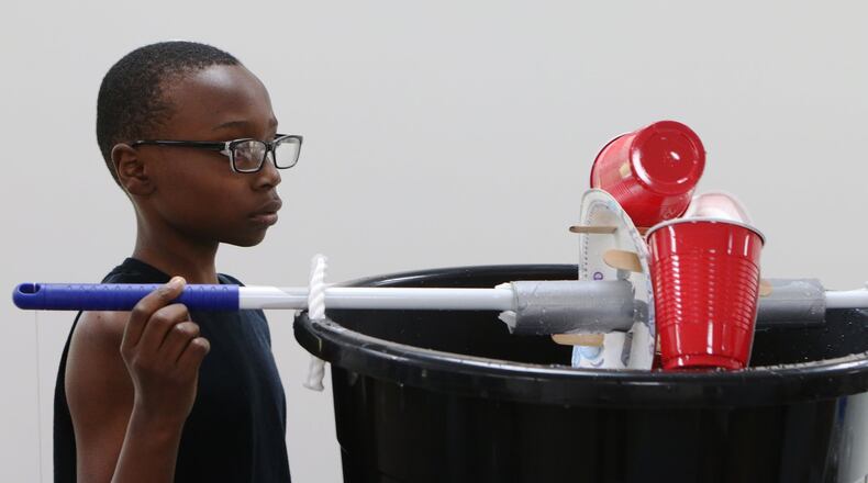June 5, 2019 Cobb County: Benjamin Brown turns his group’s water wheel during the ‘Water Is Life’ collaborative youth enrichment camp at the Austell Youth Innovation Center in Austell, Georgia. The goal of the Youth Innovation Center is to provide enrichment opportunities and improve graduation rates for youth in the surrounding community. The center opened on a site previously damaged by the 2009 floods. (Christina Matacotta/christina.matacotta@ajc.com)
