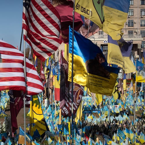 FILE - US and Ukrainian national flags wave to commemorate American volunteers, who were killed in battles with Russian troops defending Ukraine, their names are on flags, at the improvised war memorial in Independence square in Kyiv, Ukraine, Sept. 27, 2024. (AP Photo/Efrem Lukatsky, File)