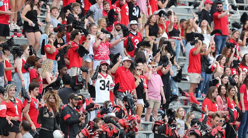 Georgia fans are decked out in red and black as they cheer on the Red Team against the Black Team during the G-Day game in April 2021 at Sanford Stadium. (Curtis Compton / Curtis.Compton@ajc.com)