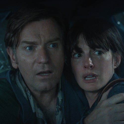 Ewan McGregor and Anne Hathaway inside a car trying to avoid a dinosaur in the sci-fi adventure "The End of Oak Street" shot in the Wisteria Gardens neighborhood of Southwest Atlanta in 2024. (Courtesy of Warner Brothers)