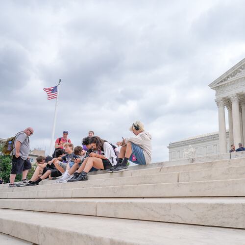 Visitors sit on the steps of the U.S. Supreme Court, Monday, June 8, 2026, in Washington. (AP Photo/Mariam Zuhaib)