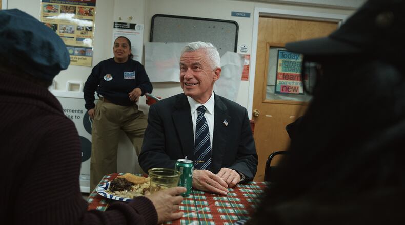 Jersey City mayoral candidate Jim McGreevey, center, listens during a community event on Wednesday, Oct. 29, 2025, in Jersey City, N.J. (AP Photo/Andres Kudacki)