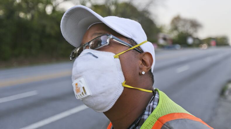 In this photo from April 11, 2013, Selena Gilreath wears a mask while working near Northside Drive in Atlanta. Pollen counts on that day rose to 8,163, the second highest count ever. JOHN SPINK / JSPINK@AJC.COM